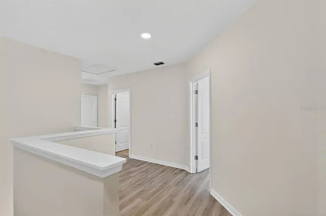 a view of a kitchen with wooden floor