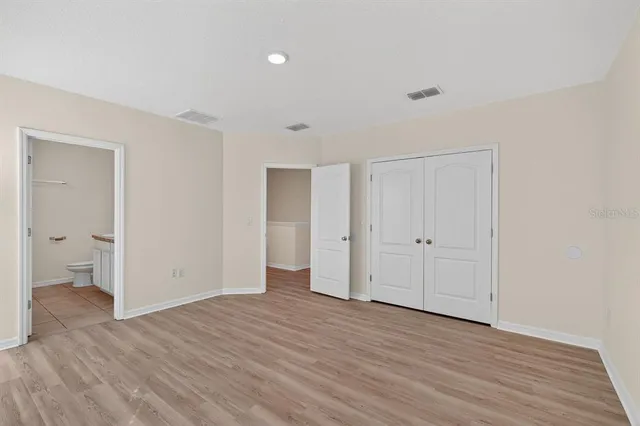 a view of an empty room and wooden floor