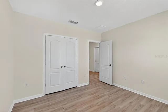a view of an empty room and wooden floor