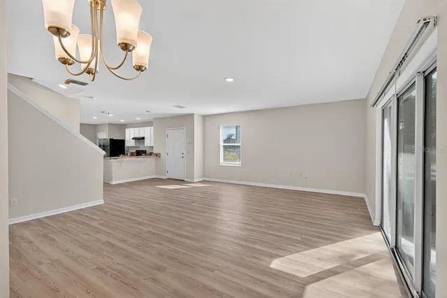a view of a livingroom with wooden floor and a large window