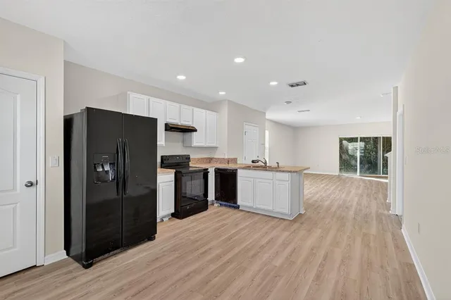 a kitchen with a refrigerator and a sink