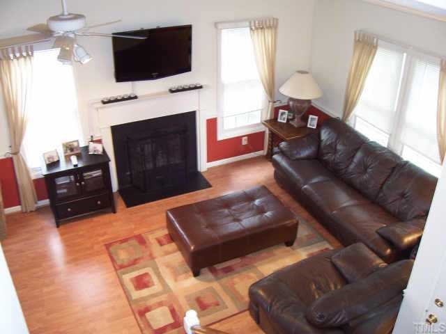 613 Thistlegate Trail Raleigh, NC 27610 - Photo 4 of 10 Living Room w/woodburning Fireplace and laminate floors