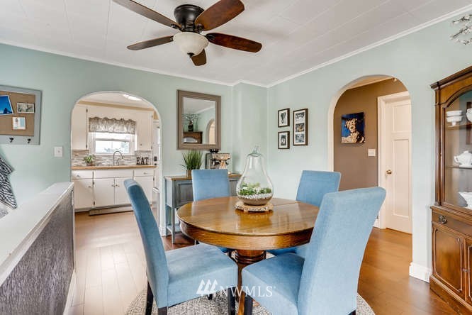 5501 Rockefeller Avenue Everett, WA 98203 - Photo 8 of 27 a view of a dining room with furniture and a chandelier fan