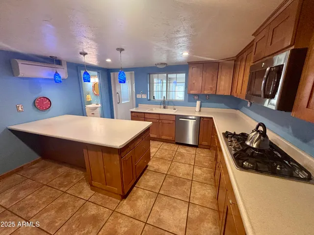 a kitchen with stainless steel appliances granite countertop a sink and white cabinets