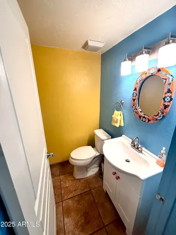 a bathroom with a bath tub sink mirror vanity and toilet