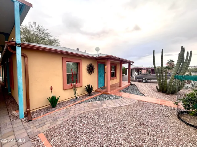 a view of a house with backyard and sitting area