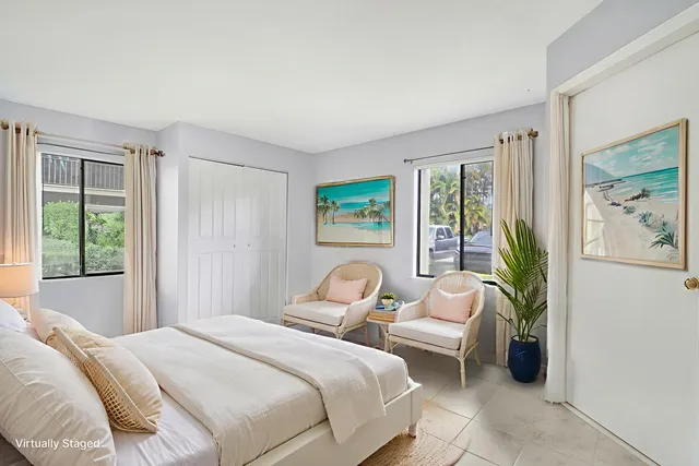 a bedroom with a bed and a large window