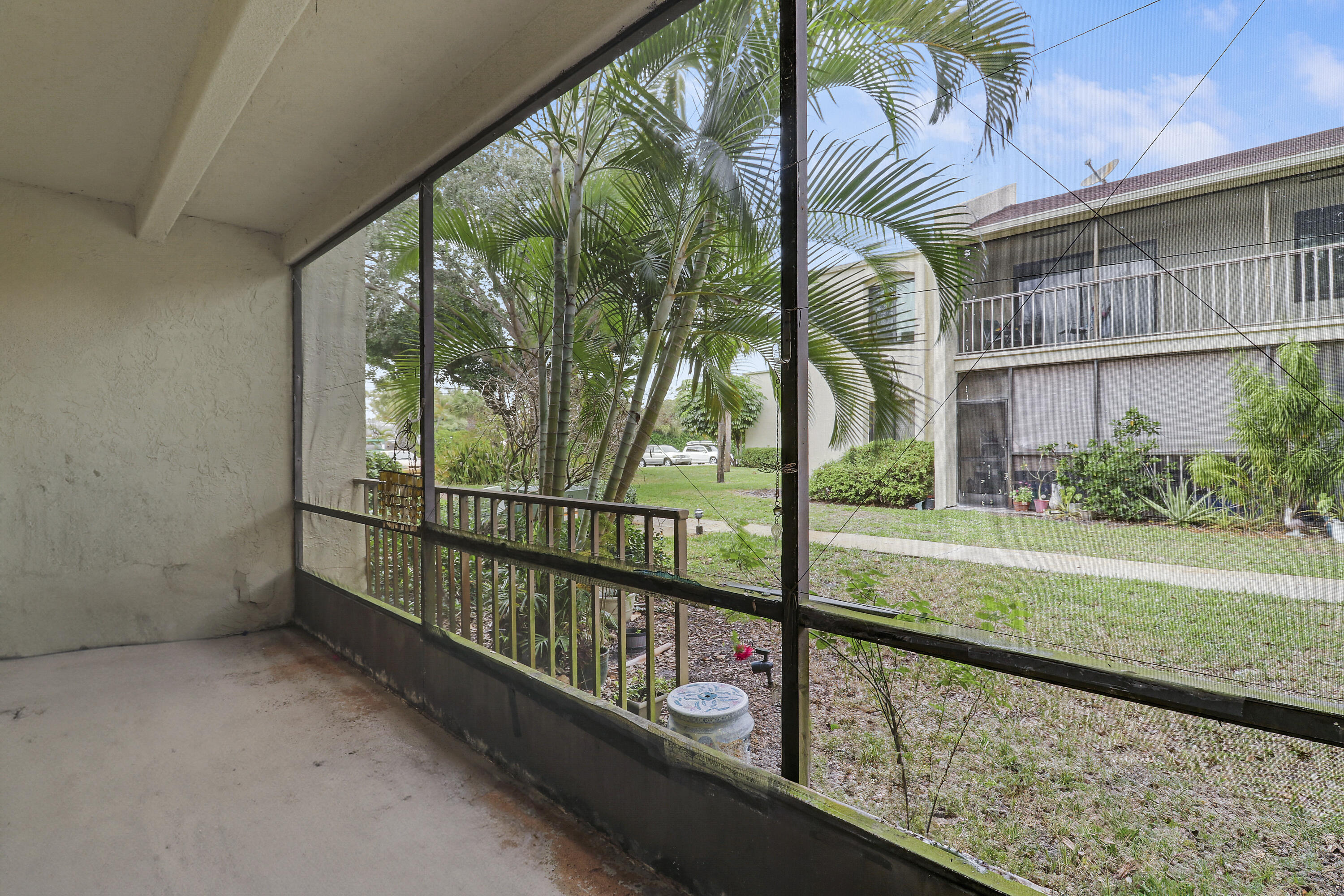 150 Pineview Road, Unit C4 Jupiter, FL 33469 - Photo 16 of 18 a view of a porch with a yard