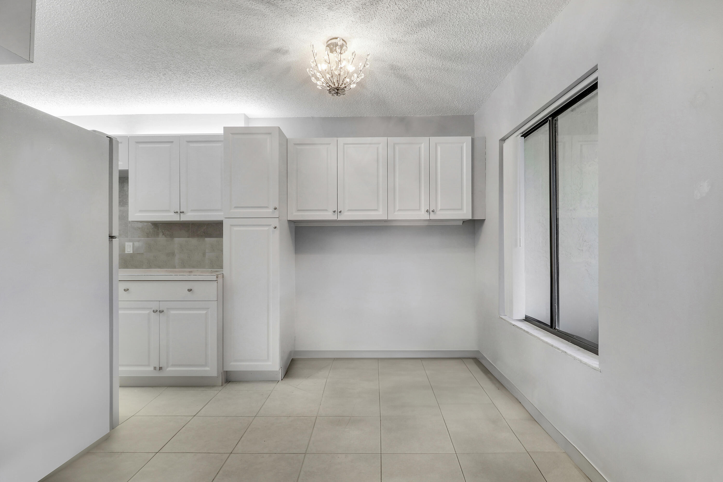 150 Pineview Road, Unit C4 Jupiter, FL 33469 - Photo 6 of 18 a view of cabinets and kitchen with a sink