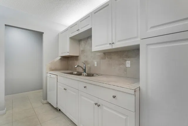 a kitchen with white cabinets