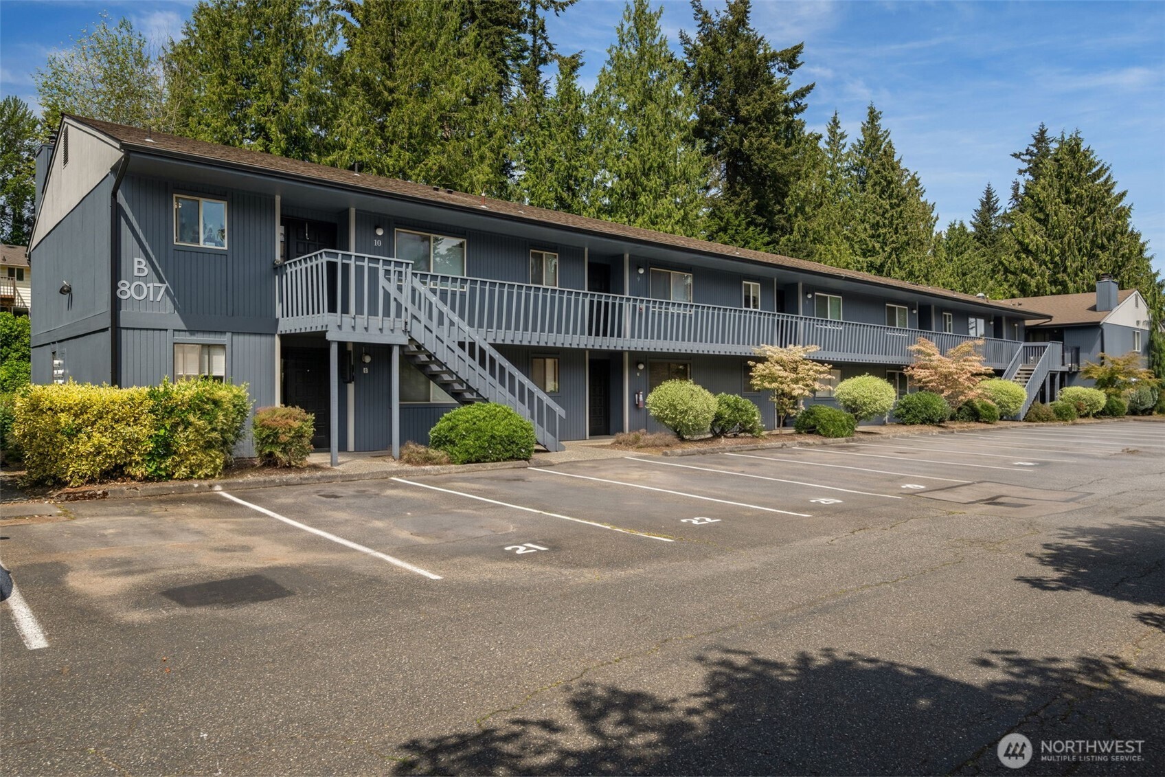 8017 196th Street Southwest, Unit 6B Edmonds, WA 98026 - Photo 20 of 23 a front view of a house with a yard and potted plants