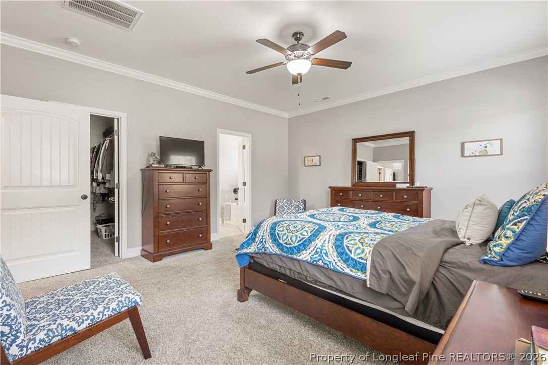 137 Minter School Road Sanford, NC 27332 - Photo 25 of 50 a bedroom with a bed and a chandelier