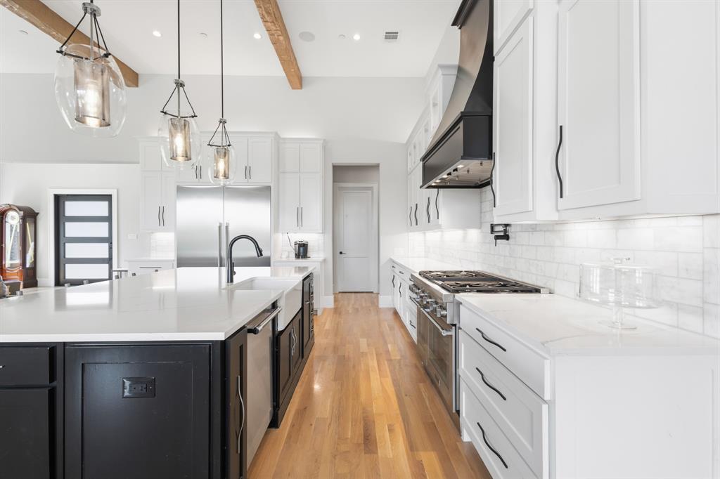 1285 Rimrock Drive Lucas, TX 75002 - Photo 11 of 37 a kitchen with stainless steel appliances granite countertop a sink a stove and cabinets