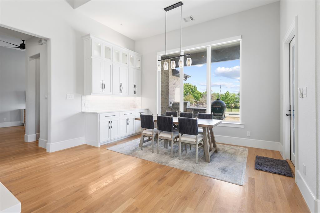 1285 Rimrock Drive Lucas, TX 75002 - Photo 13 of 37 a dining room with furniture a chandelier and wooden floor