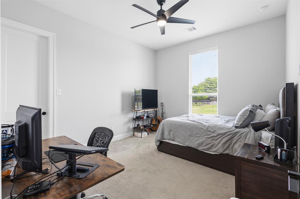 1285 Rimrock Drive Lucas, TX 75002 - Photo 29 of 37 a bedroom with a bed and a flat screen tv