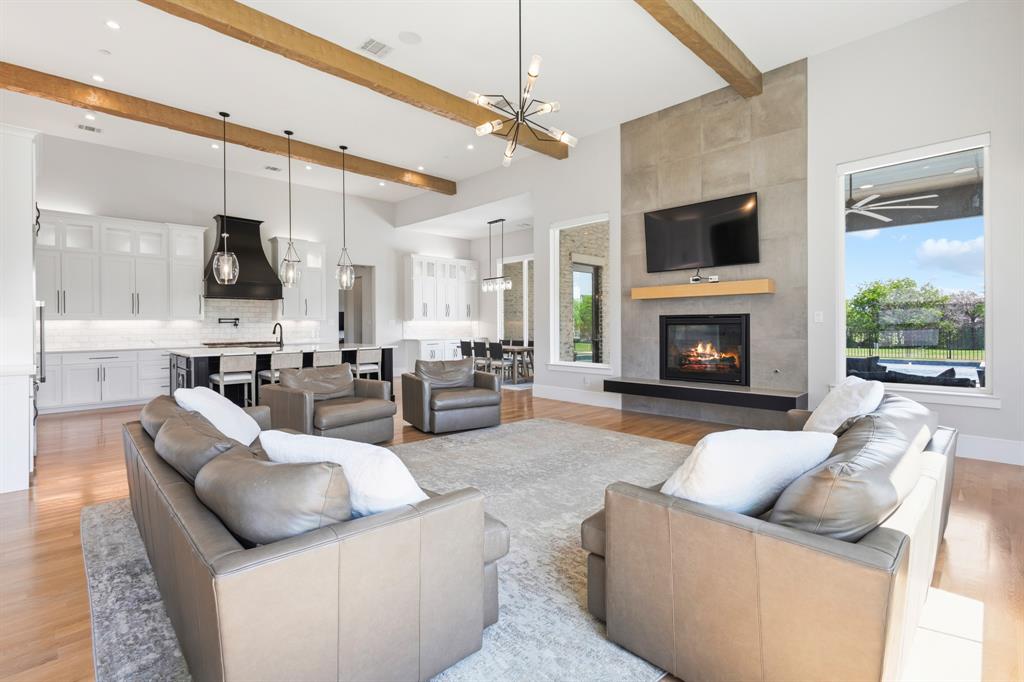 1285 Rimrock Drive Lucas, TX 75002 - Photo 8 of 37 a living room with furniture a flat screen tv and a fireplace