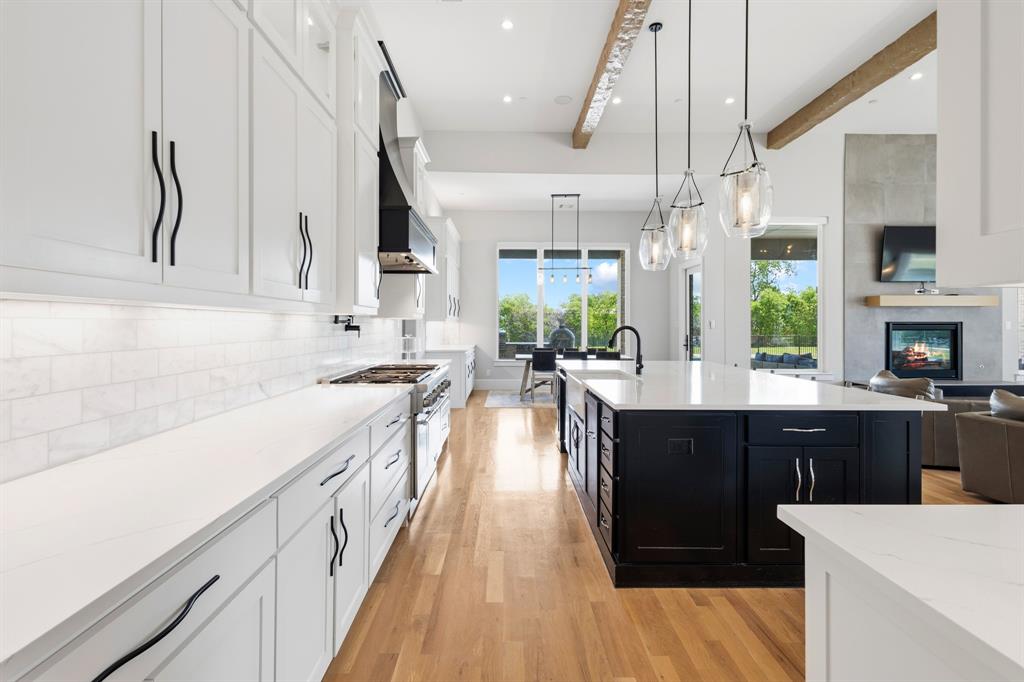 1285 Rimrock Drive Lucas, TX 75002 - Photo 10 of 37 a kitchen with stainless steel appliances kitchen island granite countertop a sink a stove and a wooden floors