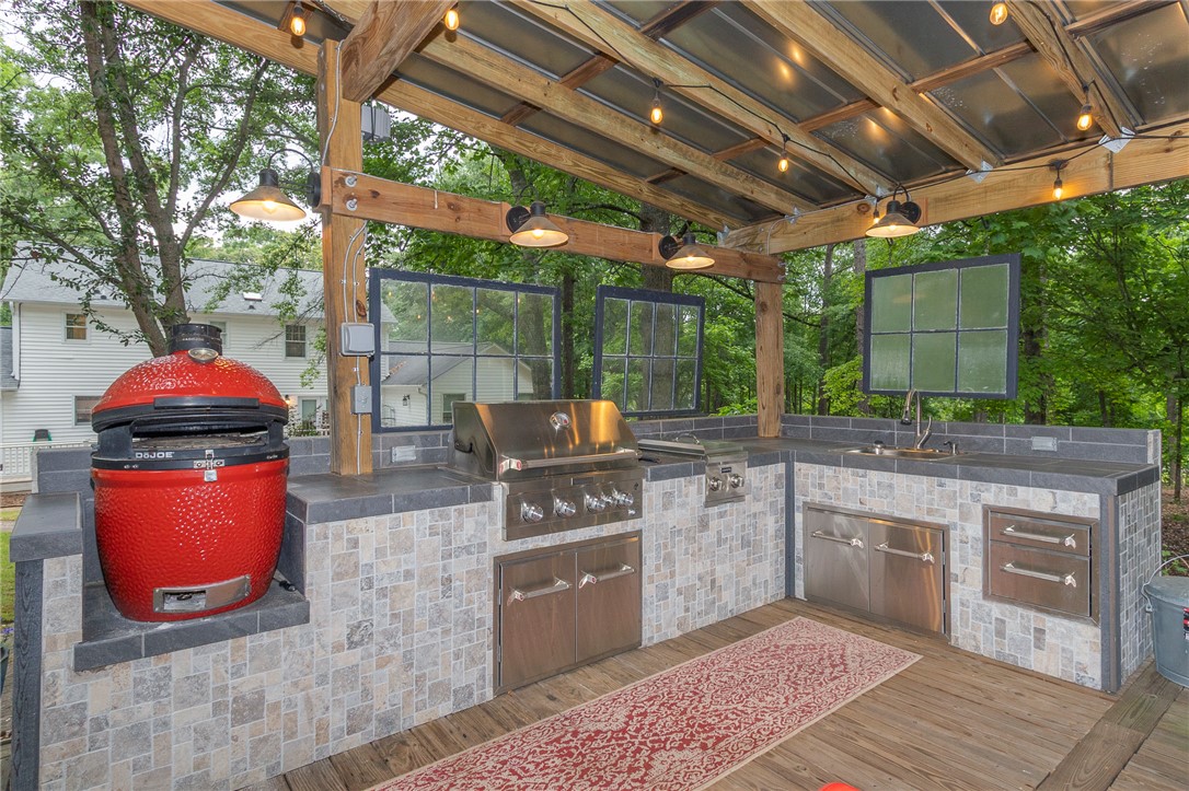 203 Oak Hollow Pendleton, SC 29670 - Photo 41 of 50 An inviting outdoor kitchen, perfect for alfresco dining, features a built-in grill and ample counter space.