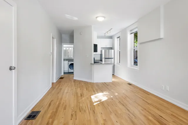 a view of a kitchen with wooden floor and a kitchen