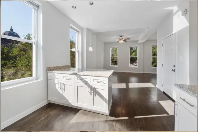 a large white kitchen with a large window