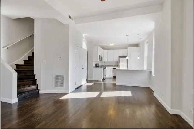 a view of kitchen with wooden floor and electronic appliances