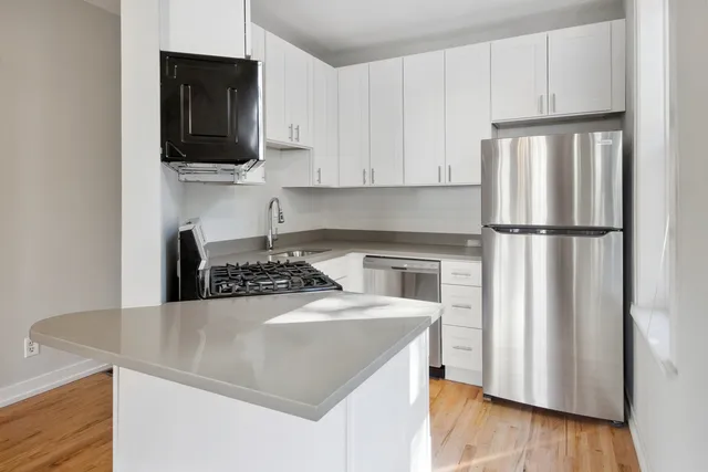 a kitchen with a appliances a sink and a microwave
