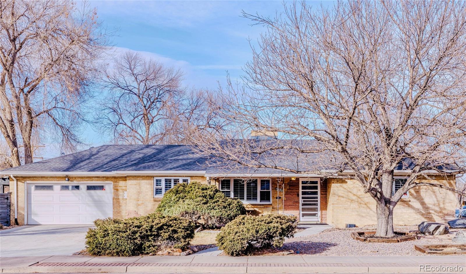 7005 West 44th Avenue Wheat Ridge, CO 80033 - Photo 1 of 37 a front view of a house with a tree