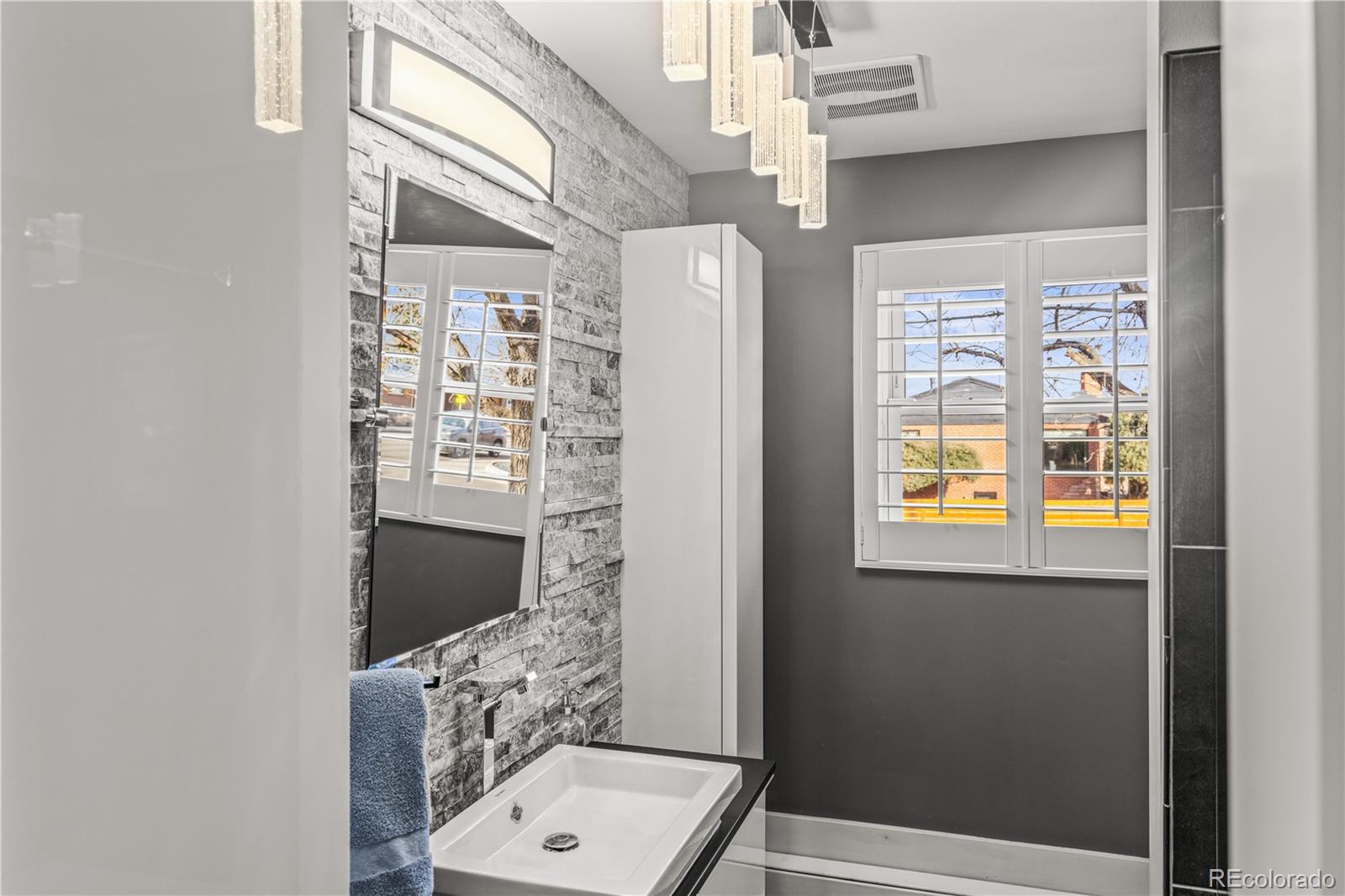 7005 West 44th Avenue Wheat Ridge, CO 80033 - Photo 17 of 37 a bathroom with a toilet and a shower curtain