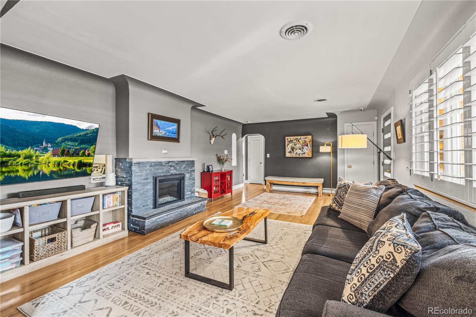 7005 West 44th Avenue Wheat Ridge, CO 80033 - Photo 2 of 37 a living room with furniture and a fireplace