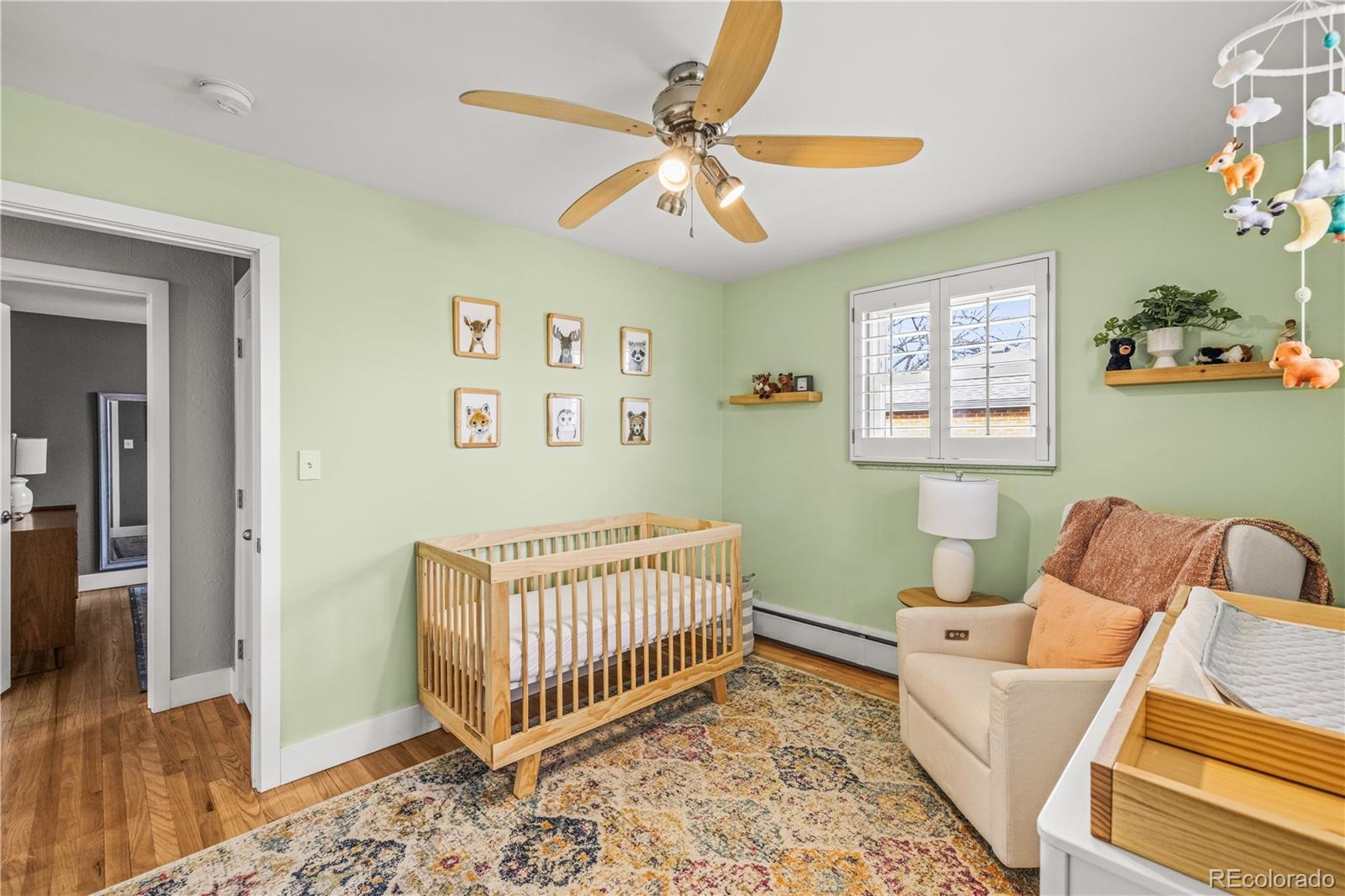7005 West 44th Avenue Wheat Ridge, CO 80033 - Photo 21 of 37 a room with a baby crib furniture and a window
