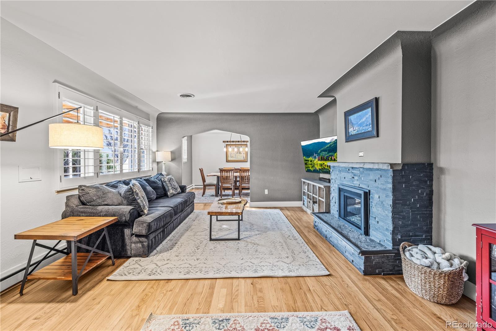 7005 West 44th Avenue Wheat Ridge, CO 80033 - Photo 6 of 37 a living room with furniture and a fireplace
