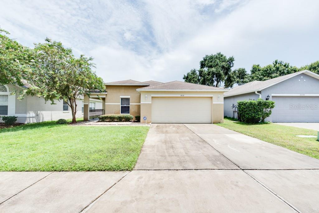 2610 Whitewood Road Mulberry, FL 33860 - Photo 1 of 1 a front view of a house with a yard and a garage