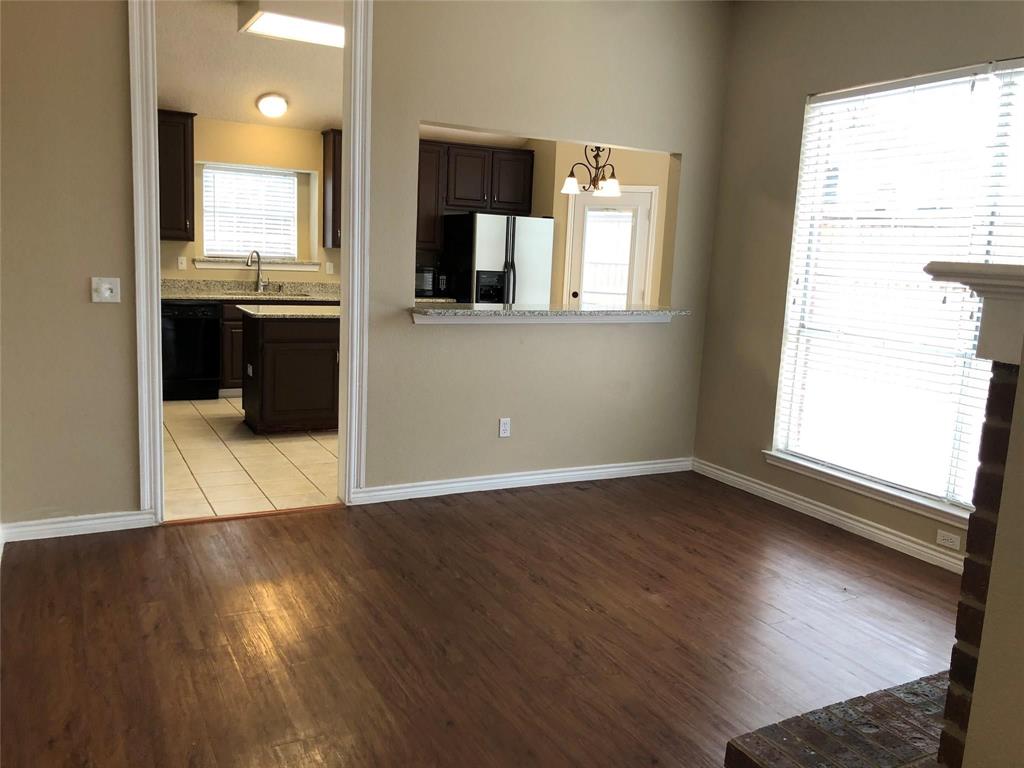 8301 Bells Street Frisco, TX 75035 - Photo 7 of 24 an empty room with wooden floor and windows