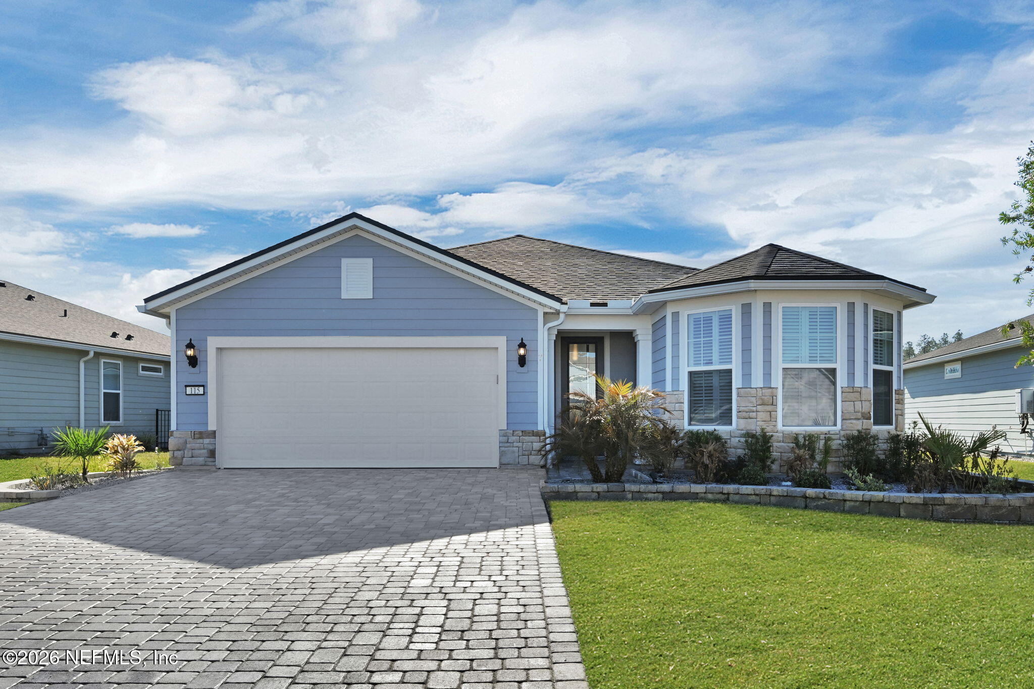 a front view of a house with garden