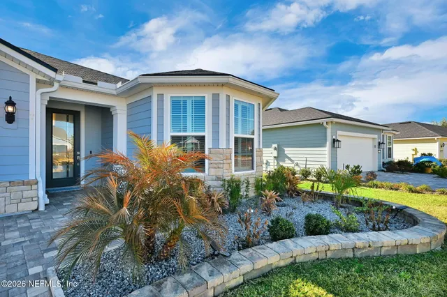 a front view of a house with garden