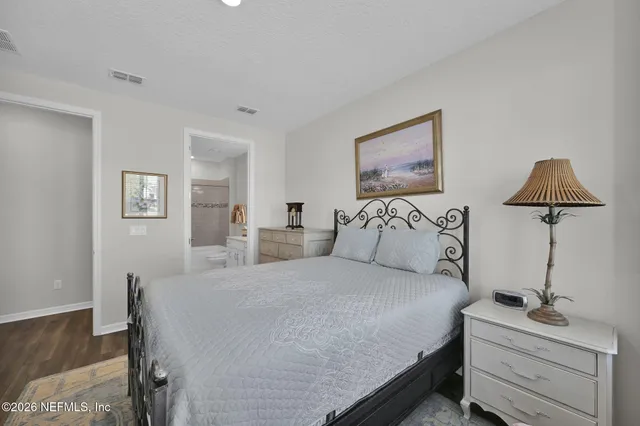 a bedroom with a bed and a lamp on table