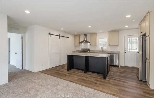 a kitchen with a refrigerator and a sink