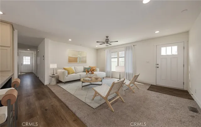 a living room with furniture and wooden floor