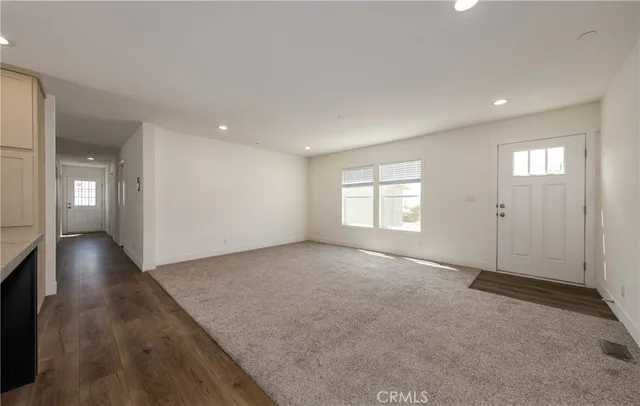 an empty room with windows and entrance