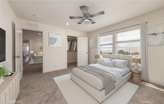 a bedroom with a large bed and a chandelier