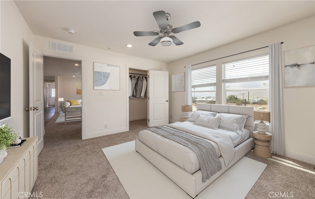 13435 Mesquite Road Whitewater, CA 92282 - Photo 21 of 29 a bedroom with a large bed and a chandelier