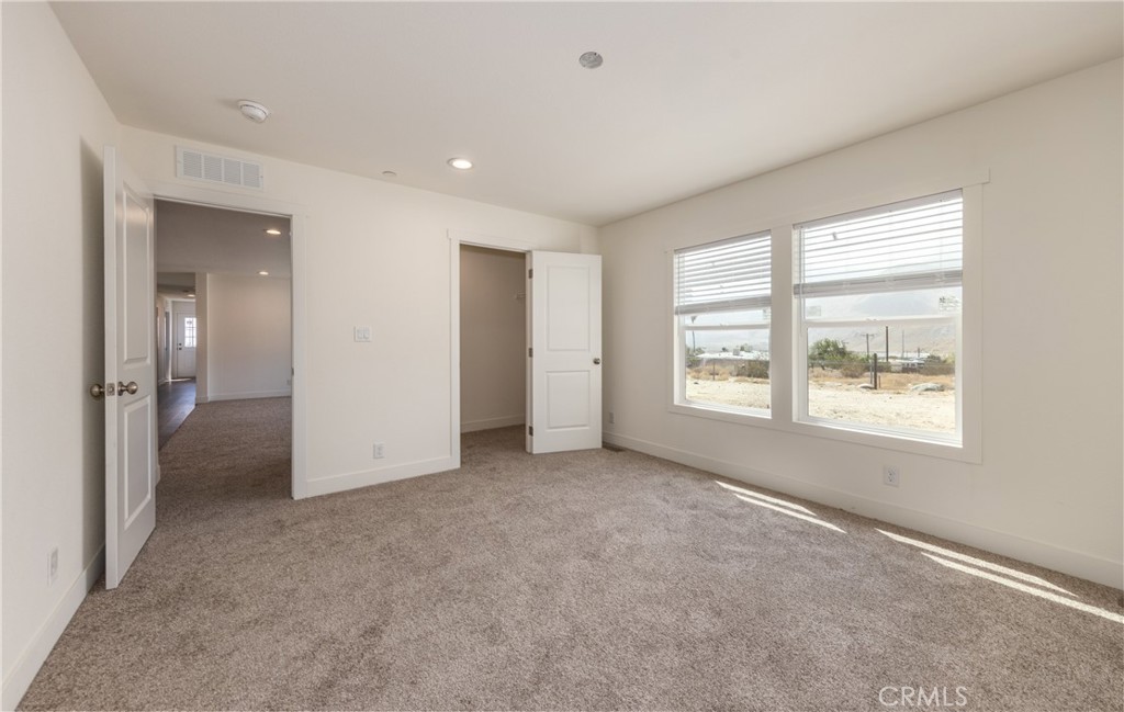 13435 Mesquite Road Whitewater, CA 92282 - Photo 22 of 29 an empty room with windows and closet