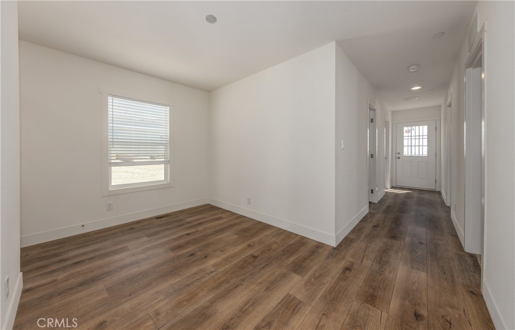 13435 Mesquite Road Whitewater, CA 92282 - Photo 24 of 29 a view of an empty room with wooden floor and a window
