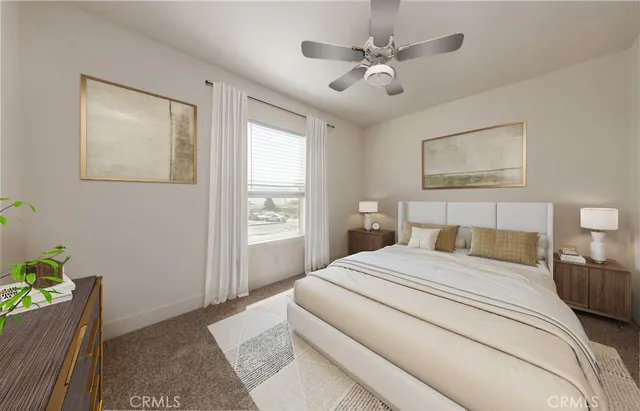 a bedroom with a bed chandelier and a window