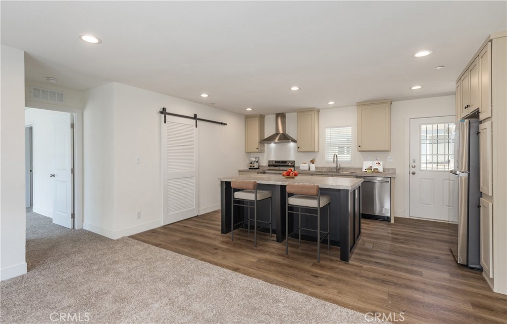 13435 Mesquite Road Whitewater, CA 92282 - Photo 10 of 29 a kitchen with kitchen island granite countertop wooden floors and stainless steel appliances