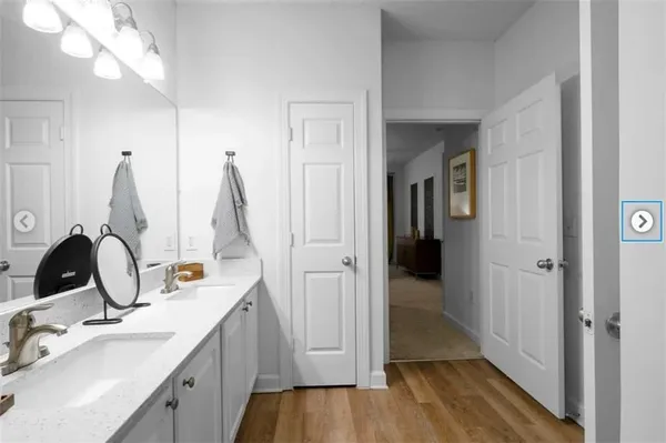 a view of patio with couches and table and chairs under an umbrella