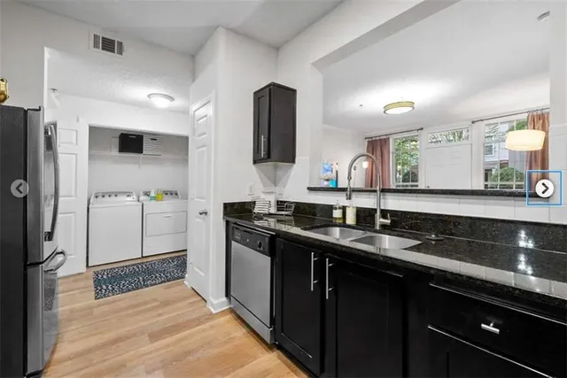 a kitchen with a sink and refrigerator
