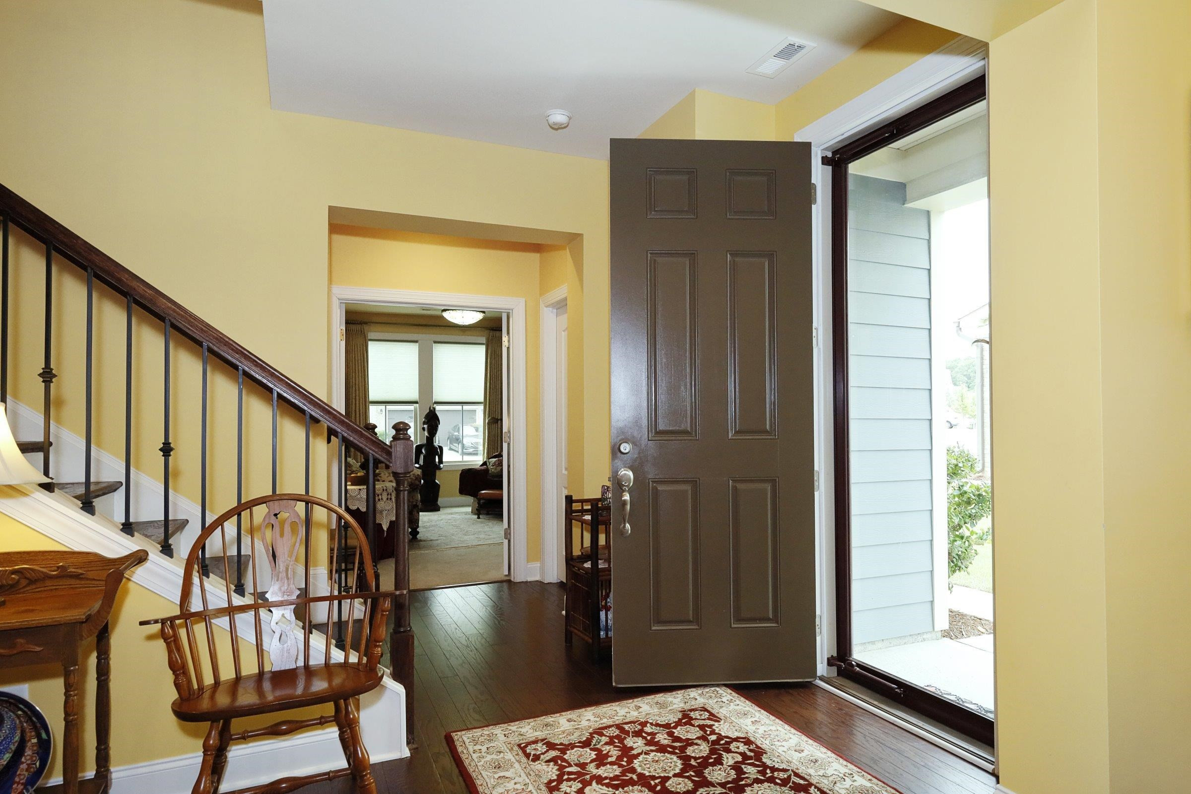 1241 Catch Fly Lane Durham, NC 27713 - Photo 2 of 44 a view of a hallway with wooden floor and staircase