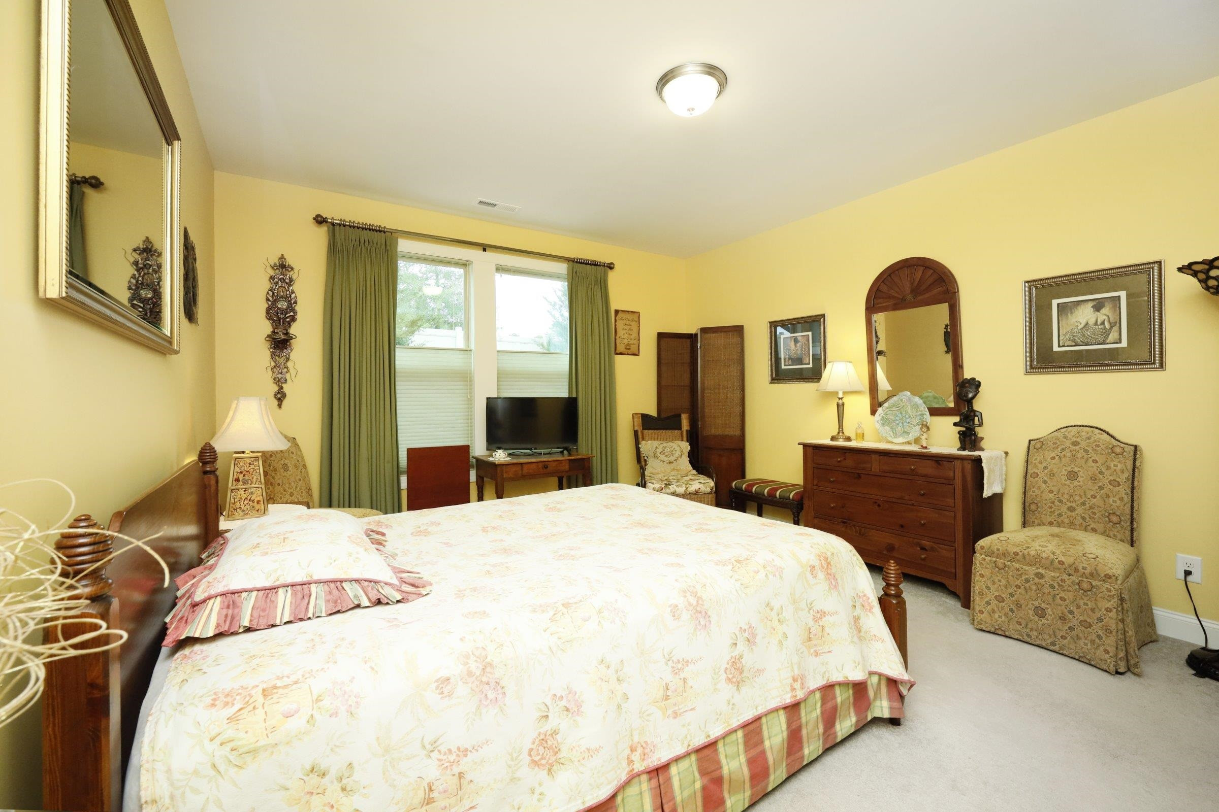 1241 Catch Fly Lane Durham, NC 27713 - Photo 23 of 44 a bedroom with a bed and dresser with mirror