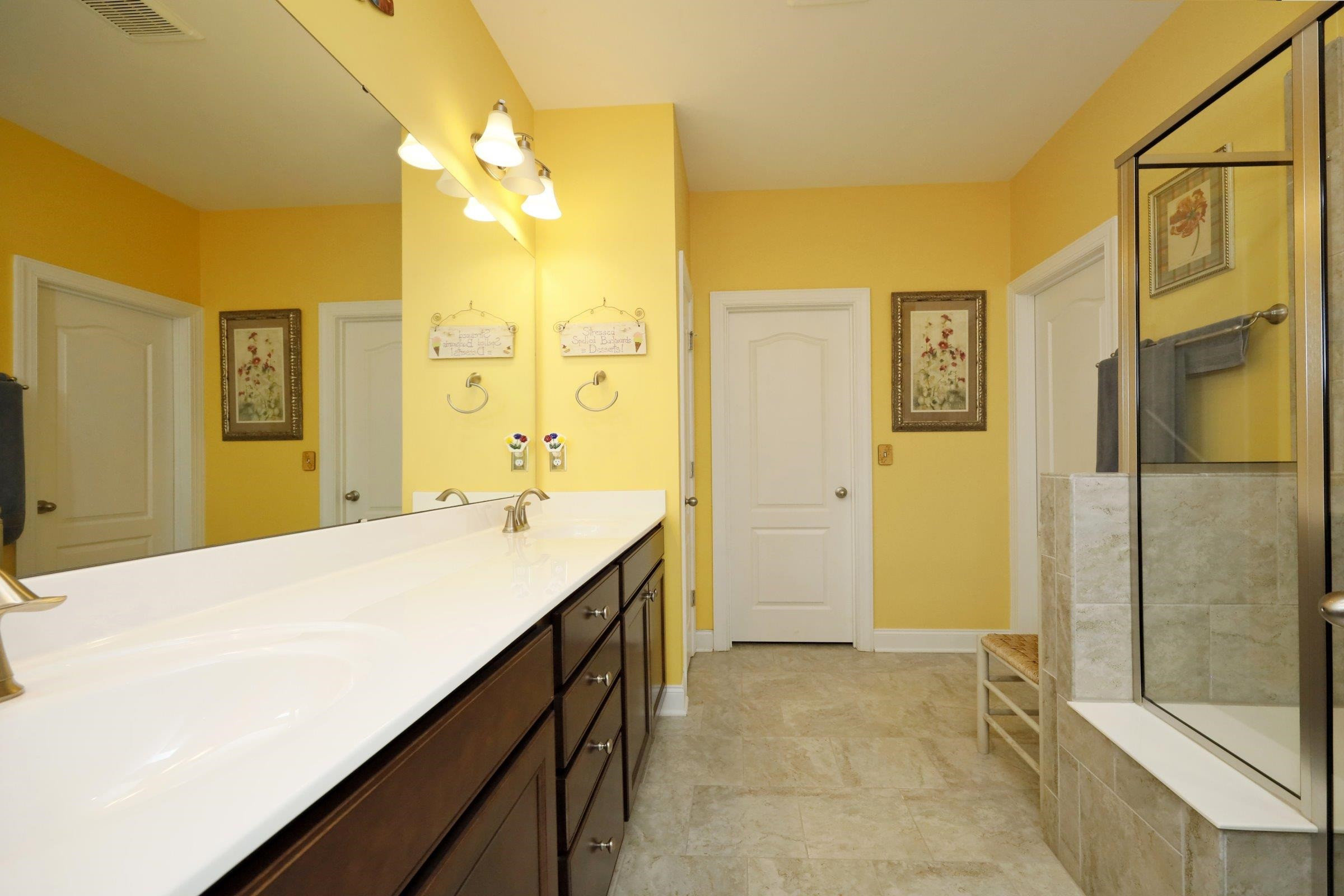 1241 Catch Fly Lane Durham, NC 27713 - Photo 24 of 44 a spacious bathroom with a shower sink and mirror